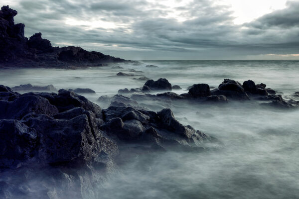 photo qui représente des rochers avec les vagues.